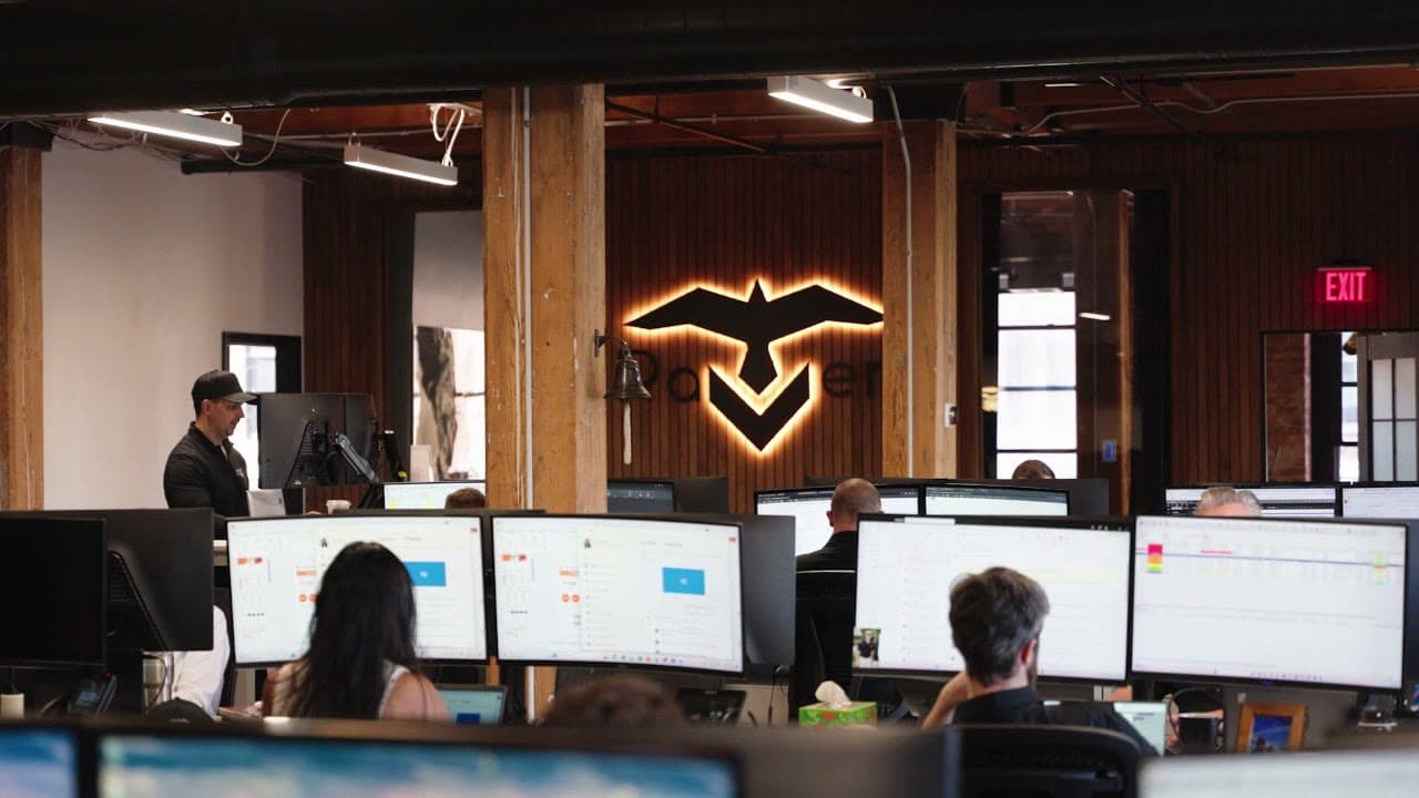 RAVEN Cargo operations center with the illuminated raven logo on the wooden office wall